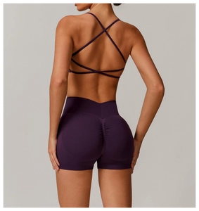 Detail of cross-back yoga bra and purple high-waisted scrunch butt sports shorts
