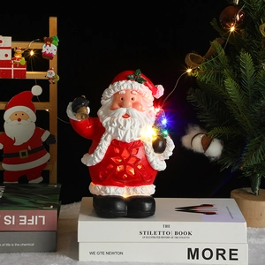 Glow Santa Claus figurine with music and LED light on a decorative book table setting