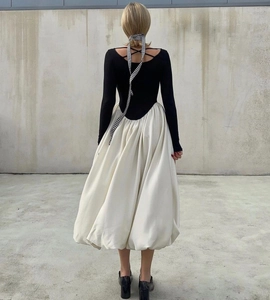 Detail of a chic backless dress with crossover straps and a white puff skirt