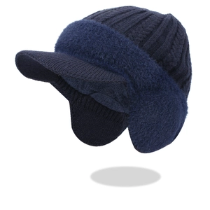 Detailed view of winter navy blue knitted hat with thick fleece lining and ear protection
