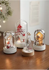 Close-up of glass dome Christmas lights with wooden bases and warm LED snow scenes
