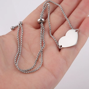 Adjustable silver stainless steel heart bolo bracelet on palm, 1.8mm box chain design