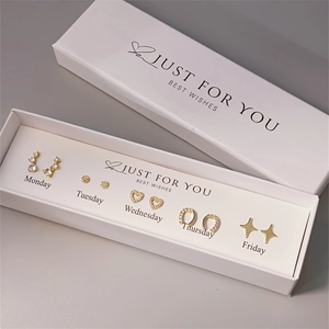 Detailed set of five golden pearl earrings in a white gift box with daily styles