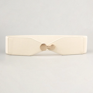 Detail of beige elastic waist belt with a polished gold circular interlocking buckle