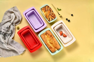 Detailed view of colorful rectangular silicone cake molds with fresh baked bread