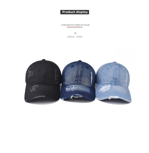 Detail of distressed denim baseball caps showing frayed edges and vintage washed texture