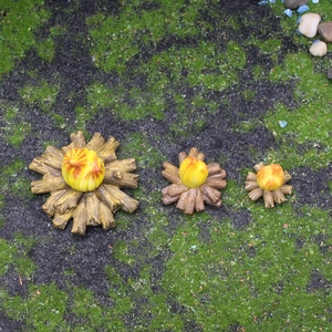 Three-piece resin miniature campfire set for garden decor on moss grass background