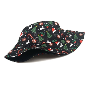 Detailed view of a black bucket hat featuring festive Christmas trees and gift patterns