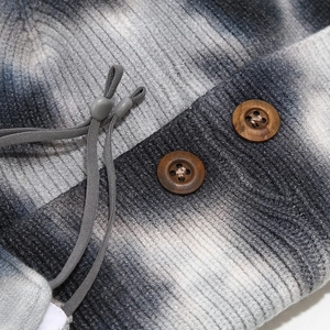 Detail of tie-dye knit hat featuring ribbed texture, wooden buttons and elastic toggle