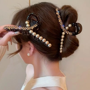 Elegant black hair claw clips with pearls and rhinestones shown on a model's updo