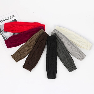 Detail of cable knit long fingerless gloves in various winter colors with ribbed cuffs
