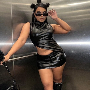 Detail of black PU leather two-piece set featuring a high neck crop top and bodycon skirt