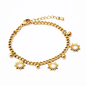 Gold stainless steel bracelet with sun pendants and beads on a clean white background