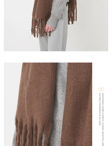 Close-up detail of soft mohair scarf with thick fringe tassels in deep brown color