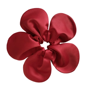 Detail shot of the wine red silk flower hair scrunchie with high-gloss satin texture