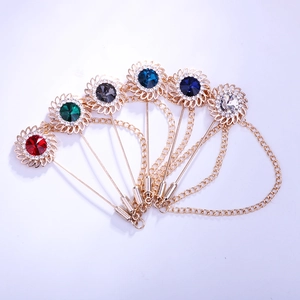 Macro view of sunflower lapel pins with colored rhinestones and hanging metal chains