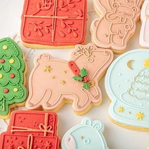 Christmas fondant cookie cutters set featuring reindeer, tree, and snow globe shapes