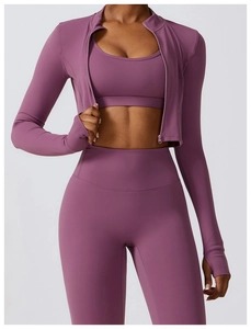 Détail d'un ensemble de yoga violet avec veste zippée, brassière et legging taille haute