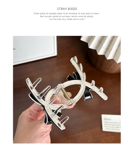 Detail of elegant bow hair claw clip showing high-transparency acetate and strong metal spring