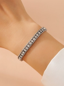 Close-up of a silver stainless steel bracelet featuring two rows of clear zircons