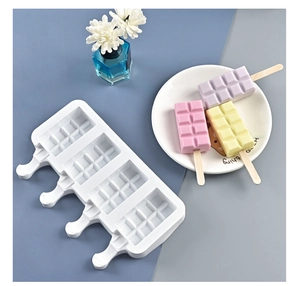 Detailed view of 4-cavity white silicone popsicle mold with finished ice cream bars