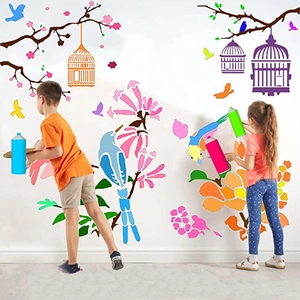 Kids using plant and bird PET stencils for DIY wall painting with spray colors