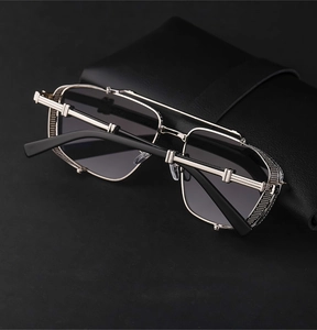 Detail of silver steampunk sunglasses with intricate metal mesh and double bridge