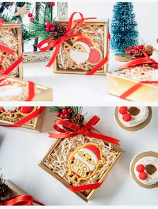 Christmas gift box with Santa Claus cookies, gold-edged packaging, and festive red ribbons