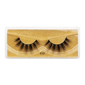 Close-up of 3D faux mink eyelashes style #101 in a glitter gold packaging box