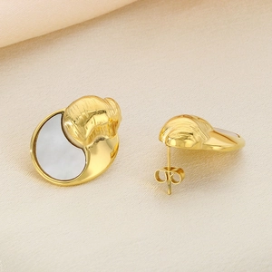 Minimalist gold crescent shell earrings on beige silk fabric background, high-quality view