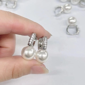 Elegant U-shaped silver drop earrings with white pearls and sparkling cubic zirconia