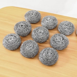 Set of 10 large stainless steel scouring pads for kitchen dish cleaning on a wooden surface