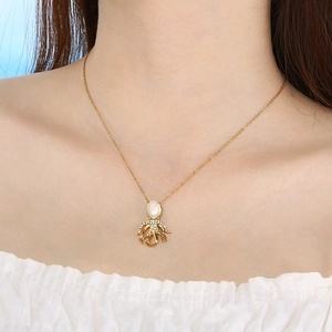 Golden octopus necklace with opal pendant and diamonds worn by a fashion model