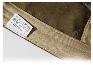 Detailed macro view of 100% cotton sweatband and premium stitching on khaki military cap