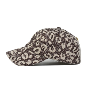 Close-up of leopard print knitted baseball cap showing thick textured jacquard fabric