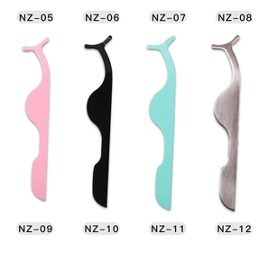 Flat lay of colorful stainless steel eyelash applicators in pink, green, and black