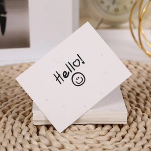 White cardboard jewelry display card with Hello! text and heart for earring packaging