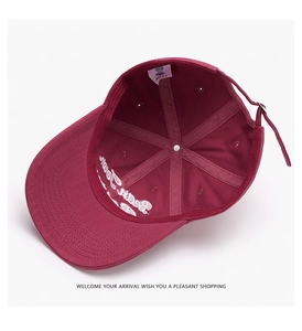 Detail view of burgundy baseball cap interior with reinforced seams and adjustable strap