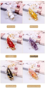 Detail view of resin koi fish figurines with natural crystal stones and gold foil