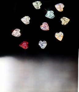 Detailed view of 5.5mm heart-shaped colored crystals with titanium steel screw backings