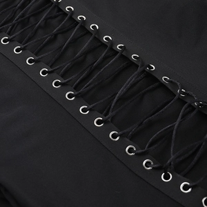 Detailed close-up of lace-up design with metal eyelets on a black slim-fit dress