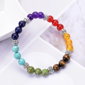 Handmade chakra beaded bracelet with natural tiger eye and turquoise stones on marble base