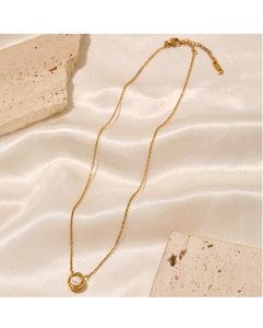 Detail of gold pearl necklace on silk with lobster clasp and adjustable extension chain