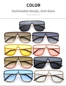Flat lay of oversized one-piece sunglasses in nine fashion colors with metal frames