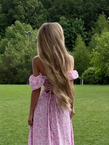 Detail of the backless tie-up design and puff sleeves on this pink floral maxi dress