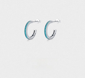 Detailed close-up of S925 sterling silver stamp on C-shaped turquoise bead earrings