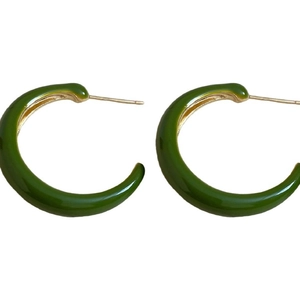Minimalist green enamel C-shaped stud earrings with silver needles on a white background