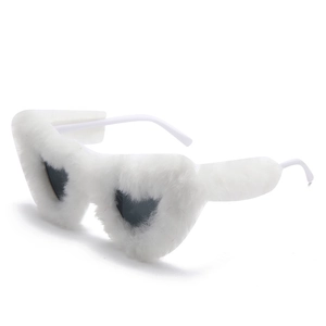 Detail of heart-shaped sunglasses featuring fuzzy white faux fur frames and dark lenses