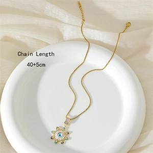 Gold evil eye sun pendant necklace with zircon and enamel on white display plate