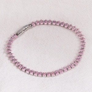Macro detail of marquise-cut pink cubic zirconia tennis bracelet with silver clasp
